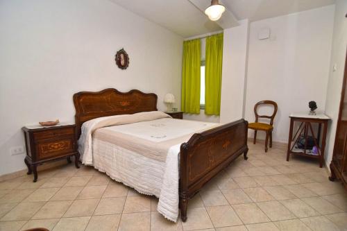 a bedroom with a large bed and a green window at iL GeLsoMiNo in Brandizzo