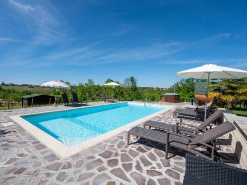 a swimming pool with two chairs and an umbrella at Holiday Home Agriturismo I Tre Tigli by Interhome in Serravalle dʼAsti