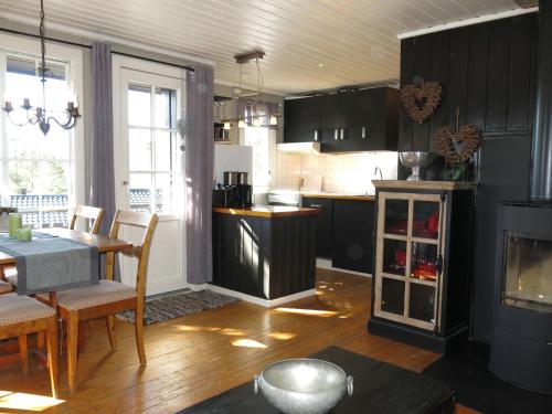 a kitchen with a table and a dining room at Holiday Home Evabu - SOW069 by Interhome in Øyuvstad