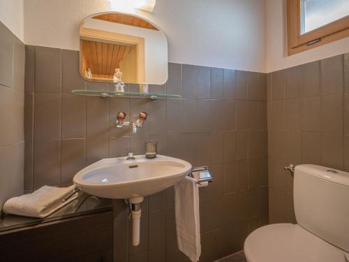a bathroom with a sink and a toilet at Chalet Phipalo by Interhome in Ovronnaz