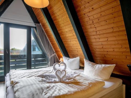 a bedroom with a bed with two hearts on it at Holiday Home Fedderwardersiel-5 by Interhome in Fedderwarderdeich