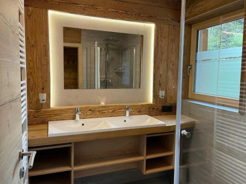 a bathroom with a sink and a mirror at Apartment Eberharter-5 by Interhome in Aschau