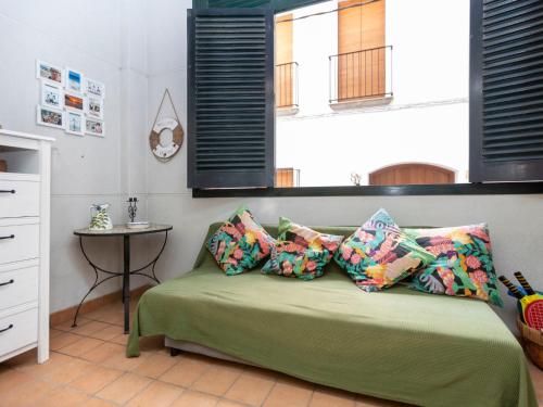 a bedroom with a bed with pillows and a table at Apartment Pomeres by Interhome in Tossa de Mar