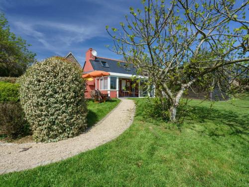 a house with a tree and a gravel path at Holiday Home Entre terre et mer by Interhome in Pouldreuzic