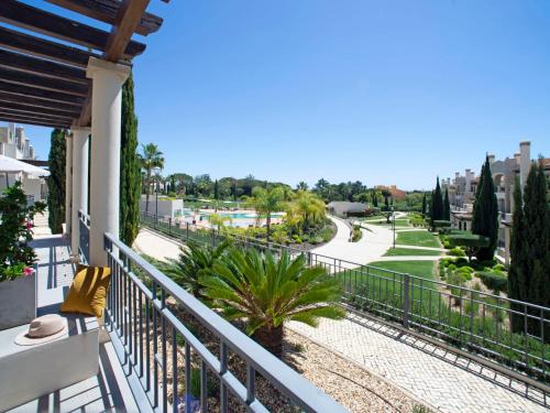 a balcony with a view of a golf course at Apartment Pine Hills Ambar by Interhome in Vilamoura
