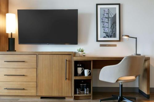 a desk with a television and a chair in a room at Hyatt Place Fort Worth/TCU in Fort Worth