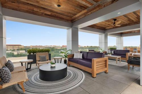 a patio with couches and chairs and a table at Hyatt Place Fort Worth/TCU in Fort Worth