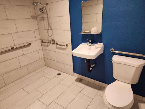 a bathroom with a toilet and a sink and a shower at Travelodge by Wyndham Stockton in Stockton