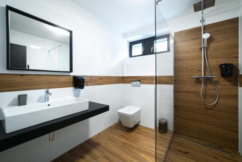 a bathroom with a sink and a shower at Lidový dům Opava in Opava