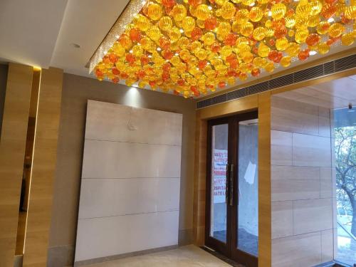 a lobby with a ceiling filled with colorful flowers at Country Green Hotel & Banquet in Bareilly