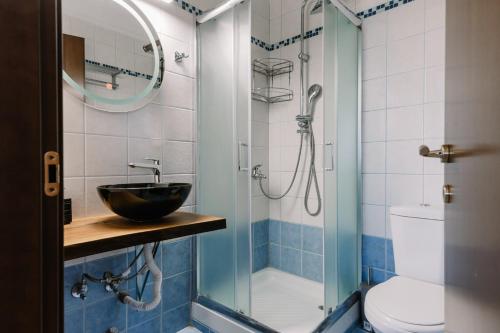 a bathroom with a sink and a glass shower at Zandre shiny apartment in Nea Potidaea
