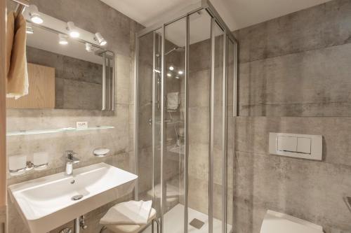 a bathroom with a sink and a shower at Haus Sonnenheim in Längenfeld
