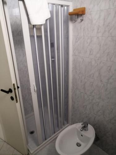a bathroom with a shower and a white sink at Ute Hotel in Lido di Jesolo