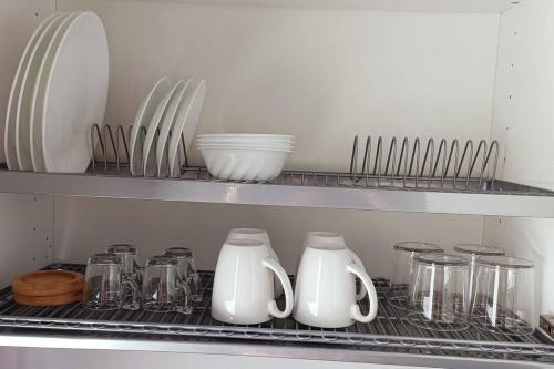 a shelf with jars and vases on it in a kitchen at Boutique apartment Alla Dolce Vita in Vicenza