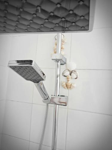 a shower with a shower head in a bathroom at Hurghada Village sea view in Hurghada