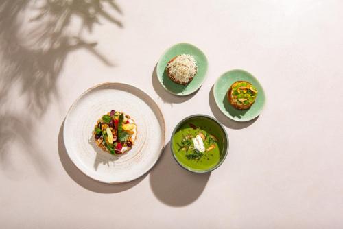 three plates of food sitting on a table at The Headland Hotel and Spa in Newquay