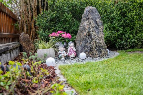 two dolls sitting in a garden in a yard at Haus Sonnenheim in Längenfeld