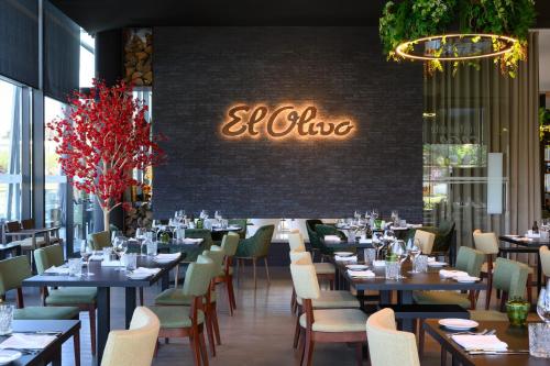 a restaurant with tables and chairs and a sign that reads all inclusive at Melia Braga Hotel & Spa in Braga