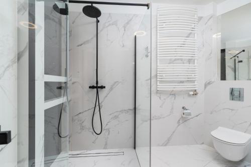 a shower with a glass door in a bathroom at Diamond Apartment by Renters Prestige in Krakow
