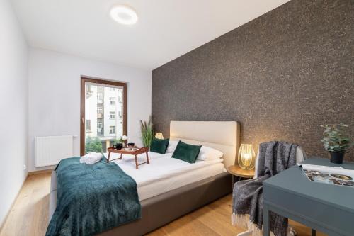 a bedroom with a bed and a wall at Diamond Apartment by Renters Prestige in Krakow
