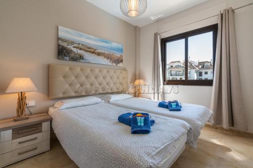een slaapkamer met twee bedden met blauwe zakken erop bij Marina duquesa836 in Castillo de Sabinillas