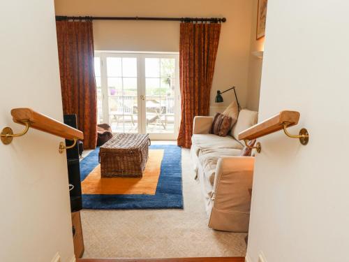 a living room with a couch and a table at Harness Lodge in Seahouses