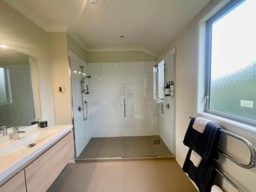 a bathroom with a shower and a sink at Benrose Park in Palmerston North