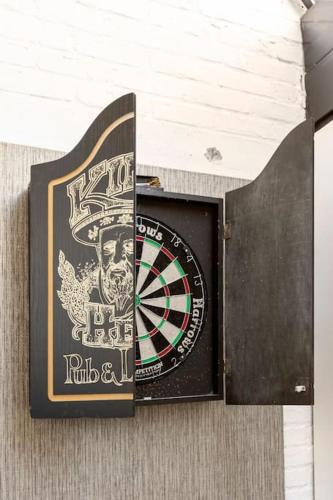a dart board next to a dartboard on a wall at Rue Haute by M&M 4 sterren bed en breakfast vlakbij Maastricht in Eben-Emael
