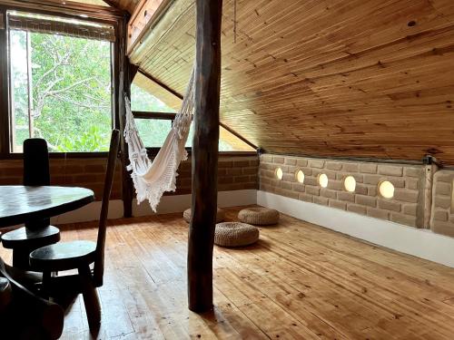 a room with a hammock in a cabin at Eco Lodge in Alto Paraíso de Goiás