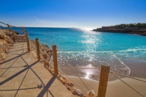 a fence on the beach near the ocean at Villa de lujo EL MIRADOR in L'Ampolla