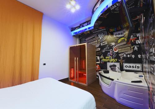 a bedroom with a bed and a wall with a boat on it at ARTEMIDE "Fiore Club" B&B SUITE SPA in Giffoni Valle Piana