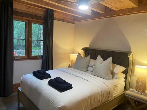 a bedroom with a large bed with two towels on it at The Cottage Burradoo in Burradoo