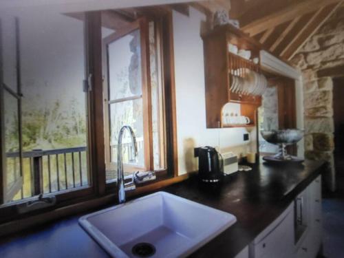 a kitchen with a sink and a window at The Cottage Burradoo in Burradoo