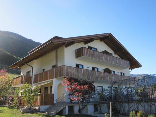 a large white building with balconies and trees at Residence Wiesenhof in Vollan