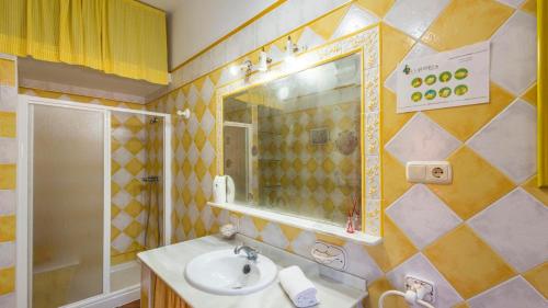 a bathroom with a sink and a mirror at La Martinica Teba by Ruralidays in Teba