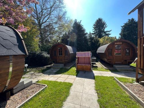 a row of small wooden huts in a yard at Hotel Columbus und Glamping in Bremerhaven
