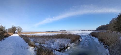 a river with snow on the side of it at Holtdeel in Gelting