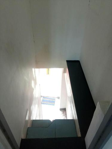 a room with a staircase with a window at De Hagan Transient Baguio City in Baguio