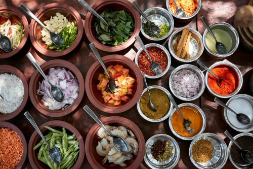 a bunch of bowls of food on a table at Wild Coast Tented Lodge - Relais and Chateaux - All Inclusive in Yala