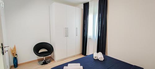 - une chambre avec une chaise noire et un bureau noir dans l'établissement Locus Apartments, à Petrčane