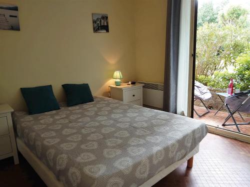a bedroom with a bed and a door to a patio at 4PA76 Appartement avec piscine et parking in Collioure