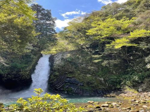 a waterfall in the middle of a river at LiVEMAX RESORT Shizuoka Amagiyugashima in Izu
