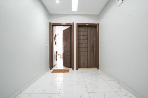 an empty hallway with two doors and a tile floor at Charming apartment in Ain Sebaa in Casablanca