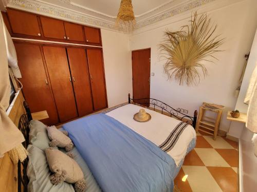 a bedroom with a bed with a hat on it at Good Wave Surf House in Tamraght Oufella