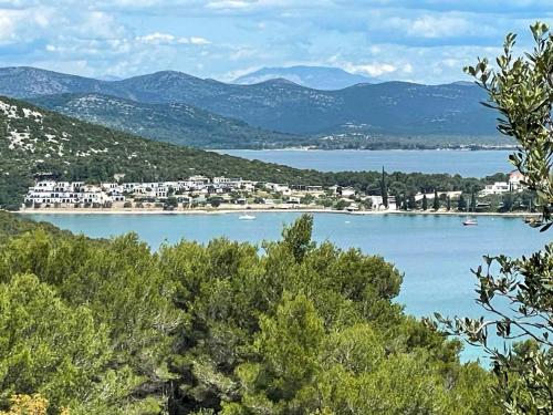 a view of a large body of water with mountains at Mobile Home Aloha in Tisno