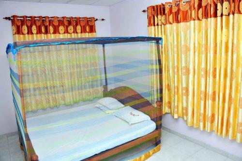 a bunk bed in a room with yellow curtains at Sunil Homestay in Tangalle