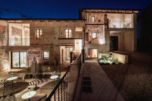 a balcony of a building with tables and chairs at Relais Chiarene in Novello
