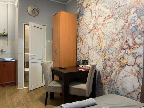 a room with a table and chairs and a map on the wall at Apartman Dacaa in Podgorica