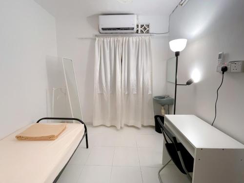 a white room with a bed and a window at Tiong Nam 32 Kuala Lumpur, 6 mins to LRT PWTC, 15 mins to KLCC in Kuala Lumpur