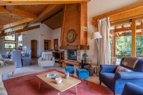 a living room with blue furniture and a fireplace at Chalet Au Gré Du Temps in Les Gets